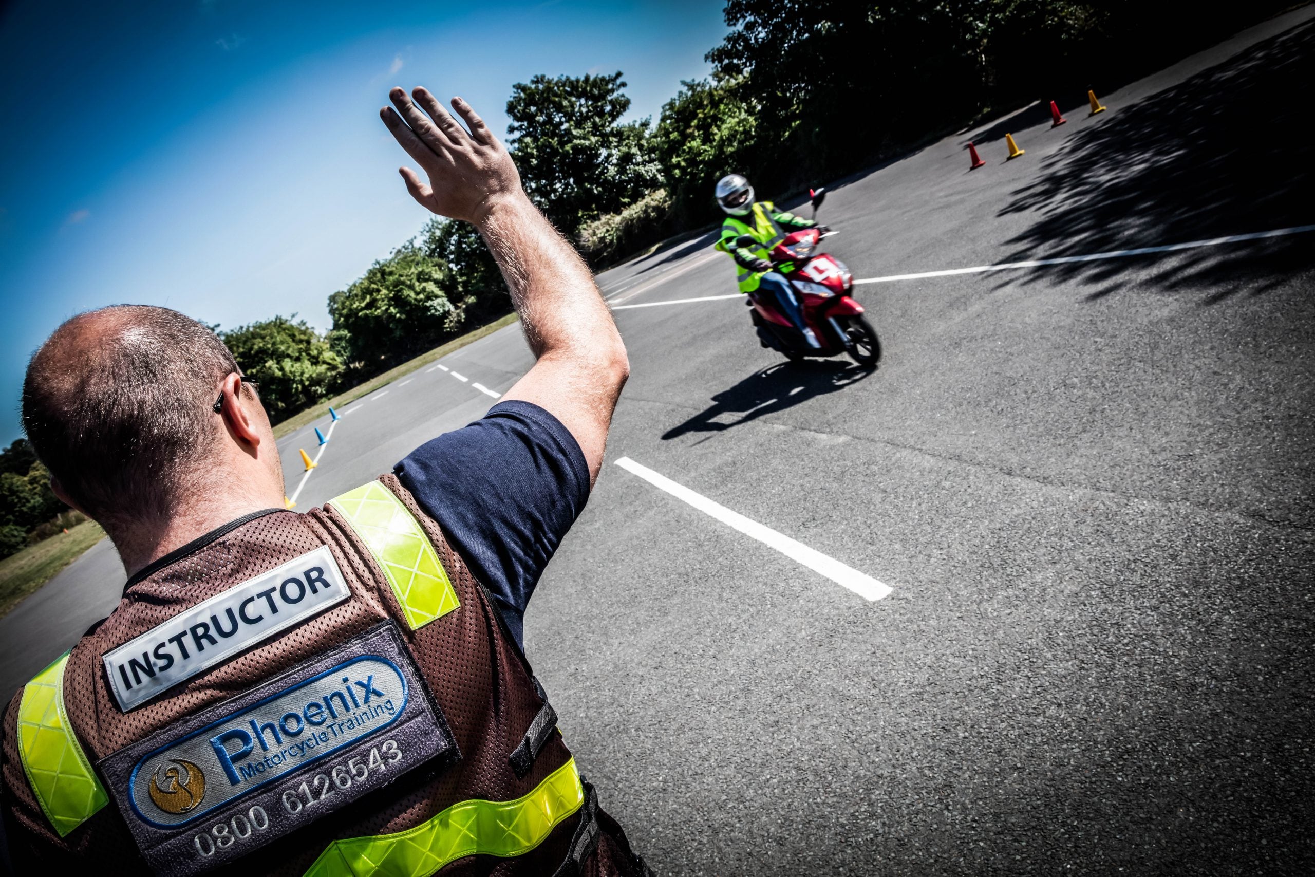 Instructor giving focused training to help student get better at motorcycle riding with a motorcycle safety course