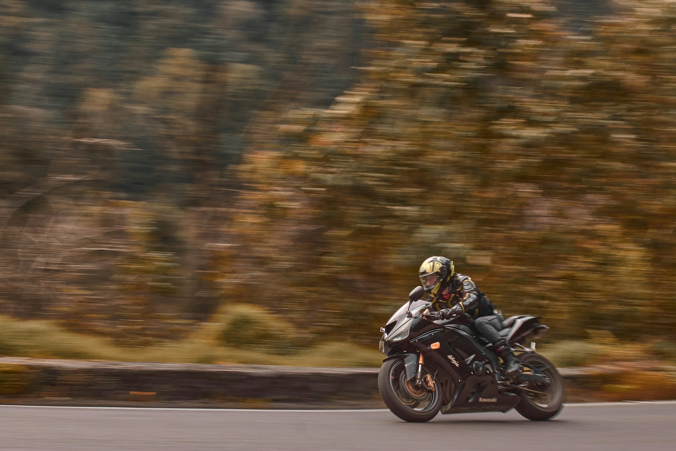 Man riding a motorcycle around a corner in the open countryside for Proskills Advanced